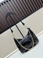 Prada Bags Batch 310 Lacquered Cowhide with Box Re－Edition NaplaK Prada Women's Shoulder or Crossbody Bag Size 22.5X18.5X7CM A bag that recreates the style grids 2005. Prada's design codes are condensed into versatile silhouettes, creating a dialogue between past present styles. Adjustable shoulder strap, parts, detachable key ring, exquisite simple leather item. The triangular logo of enamel metal exudes an iconic and charming design. - Image 2
