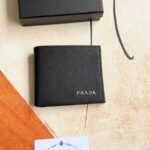 Prada Bags 75PRADA Men's Short Wallet Counter Latest Style, Official Website Synchronization, Genuine Development, Model 2M0513 # Color as shown, blue. The blue leather texture is excellent, with threaded lining. Imported white steel hardware accessories feature a complex color-blocking design, making it more fashionable and unique. Dimensions: Length 11cm, Height 9cm