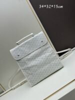 Goyard Bags Batch 240 Saint Léger Goya Dog Tooth Backpack is an ideal travel companion: features large pockets both inside outside, making lightweight practical.The snap button located on back of the bag it to be completely folded and easily stored in a suitcase.Its detachable strap allows for easy backpack transformation. 34x32x15, model 2388