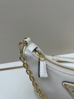 Prada Bags Batch 310 Lacquered Cowhide with Box Re－Edition NaplaK Prada Women's Shoulder or Crossbody Bag Size 22.5X18.5X7CM A bag that recreates the style grids 2005.Prada's design codes are condensed into versatile silhouettes, creating a dialogue between past present styles.Adjustable shoulder strap, parts, detachable key ring, exquisite simple leather item.The triangular logo of enamel metal exudes an iconic and charming design. - Image 6