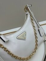 Prada Bags Batch 310 Lacquered Cowhide with Box Re－Edition NaplaK Prada Women's Shoulder or Crossbody Bag Size 22.5X18.5X7CM A bag that recreates the style grids 2005.Prada's design codes are condensed into versatile silhouettes, creating a dialogue between past present styles.Adjustable shoulder strap, parts, detachable key ring, exquisite simple leather item.The triangular logo of enamel metal exudes an iconic and charming design. - Image 4