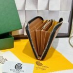 Goyard Bags 90 Goya Matignon Large Wallet is designed as long style with full closure security.It contains 12 card slots, a central zipper pocket, two large storage compartments for cards, banknotes, coins, and other daily documents. Style number: 98188 Color: Black/Brown Size: 20cm 2.3cm x 11cm - Image 6