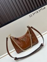 Prada Bags Batch 310 Lacquered Cowhide with Box Re－Edition NaplaK Prada Women's Shoulder or Crossbody Bag Size 22.5X18.5X7CM A bag that recreates the style grids 2005. Prada's design codes are condensed into versatile silhouettes, creating a dialogue between past present styles. Adjustable shoulder strap, parts, detachable key ring, exquisite simple leather item. The triangular logo of enamel metal exudes an iconic and charming design. - Image 4