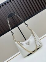 Prada Bags Batch 310 Lacquered Cowhide with Box Re－Edition NaplaK Prada Women's Shoulder or Crossbody Bag Size 22.5X18.5X7CM A bag that recreates the style grids 2005.Prada's design codes are condensed into versatile silhouettes, creating a dialogue between past present styles.Adjustable shoulder strap, parts, detachable key ring, exquisite simple leather item.The triangular logo of enamel metal exudes an iconic and charming design. - Image 2