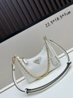 Prada Bags Batch 310 Lacquered Cowhide with Box Re－Edition NaplaK Prada Women's Shoulder or Crossbody Bag Size 22.5X18.5X7CM A bag that recreates the style grids 2005. Prada's design codes are condensed into versatile silhouettes, creating a dialogue between past present styles. Adjustable shoulder strap, parts, detachable key ring, exquisite simple leather item. The triangular logo of enamel metal exudes an iconic and charming design. - Image 6